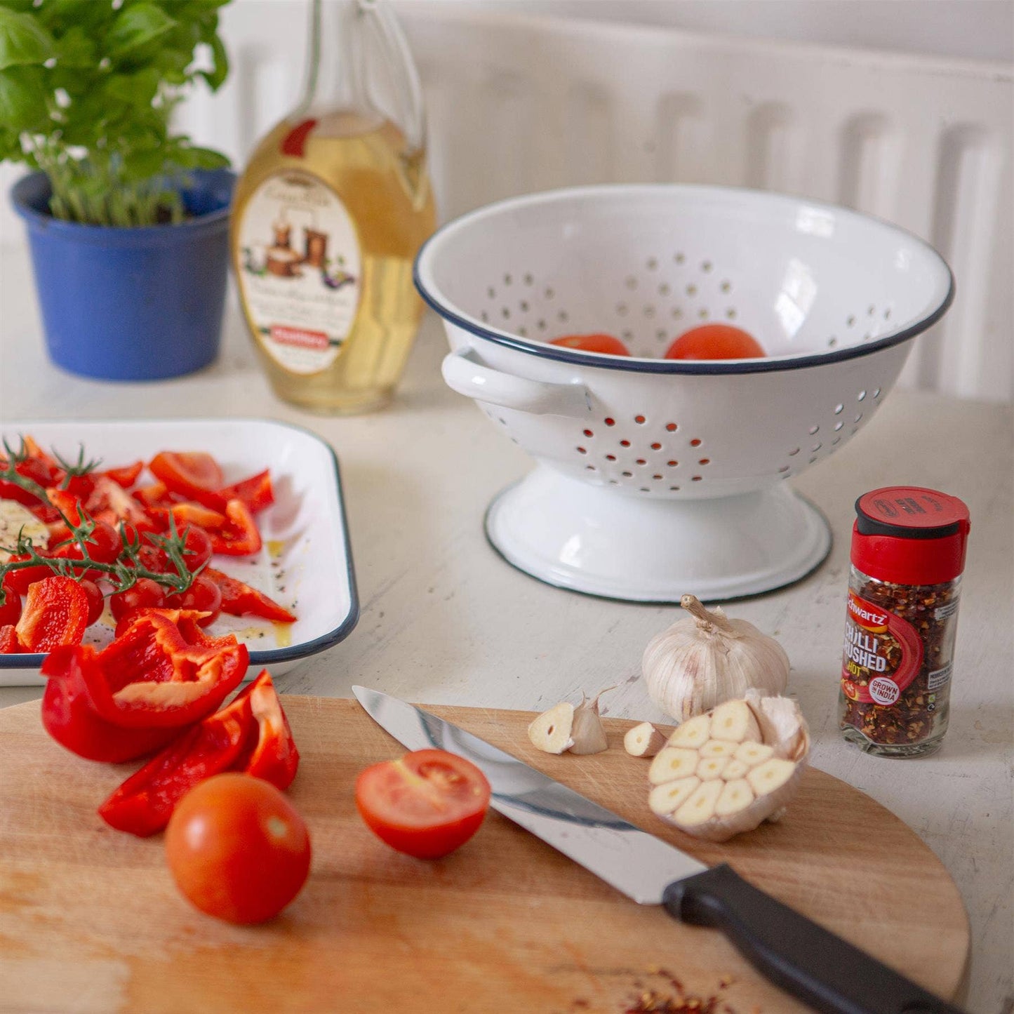 White  enamel colander with blue rim