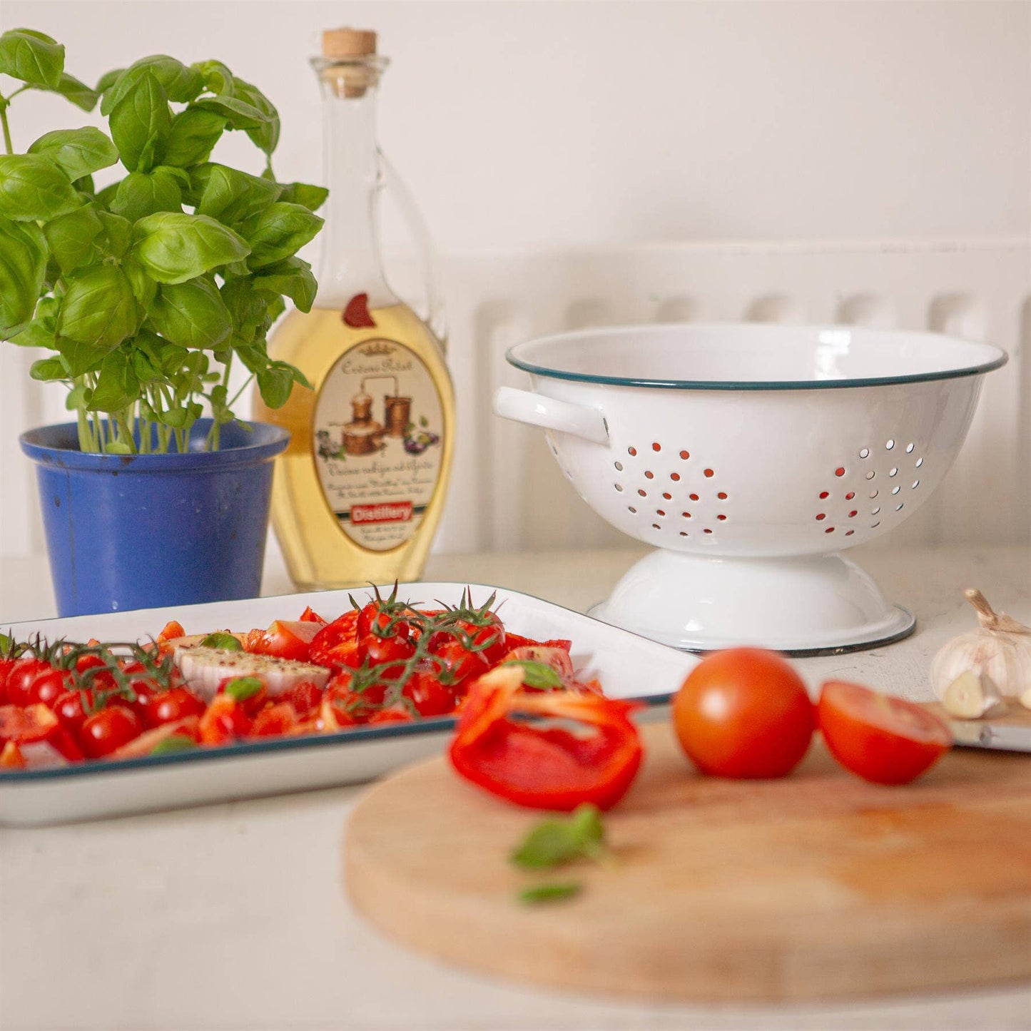 White  enamel colander with blue rim